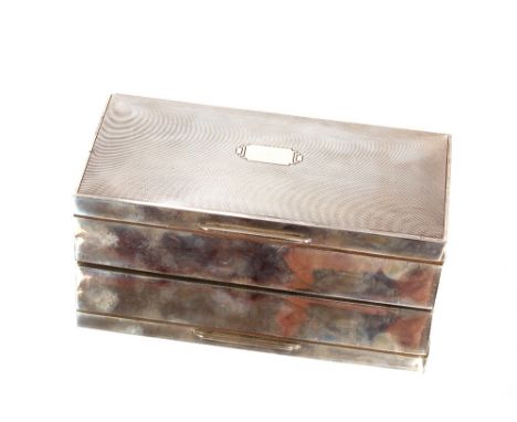 A silver cigarette box by Ernest W Haywood, Birmingham 1946, having slightly domed lid with engine turning, cedar wood lined,
