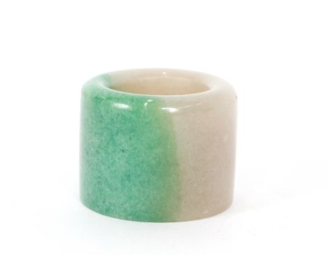 A Chinese apple green and mutton jade archers ring