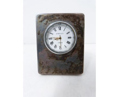 Silver desk clock by Kitney &amp; Co London. White enamel dial with black Roman numerals. Hallmarked London, 1993. Height 6.8