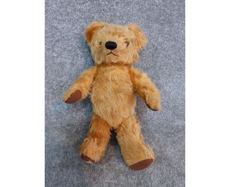 Antique yellow plush jointed Chad Valley growler teddy bear. Brown fabric pads and label to foot. Growling mechanism broken. 