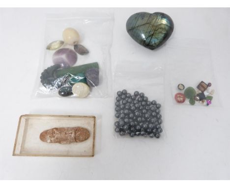 A collection of gemstones and glass stones, including a Labradorite heart, three 0.02 carat round diamonds, jade, smoky Quart