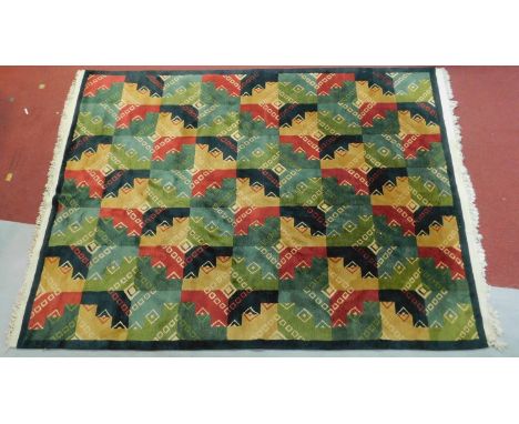 A large abstract design rug with a repeating tile pattern, fringed 310x225cm 