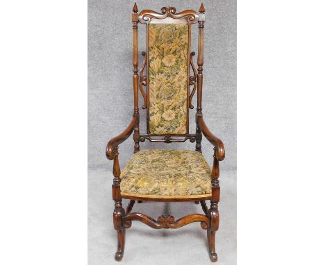 A Victorian rosewood armchair in the Carolean style in its original tapestry upholstery. H.129cm 