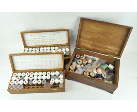 An early 20th century wooden sewing box with tray and contents, together with two boxes containing wooden beads, the first 31