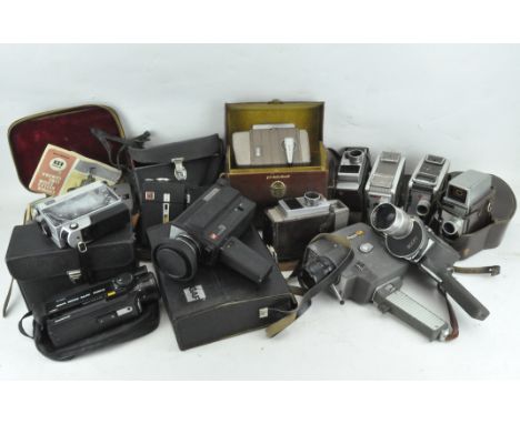 A collection of 20th century film cameras, including Holiday Meter Matic, a Kodac Brownie Movie Camera II, a Lumicon, Bell &a