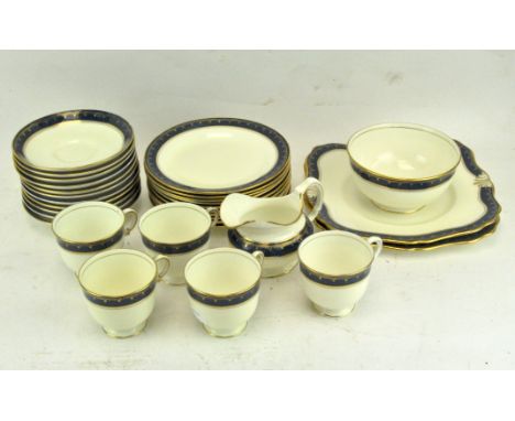 A Tuscan china "Plant" pattern part tea service with blue border, reg no 771590, including tea cups, saucers and more