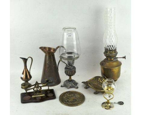 A collection of assorted brassware, to include two oil lamps, scales and more