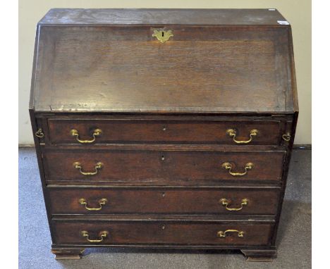 An 18th century oak bureau, with fall front enclosing drawers and pigeon holes, above four graduated drawers, on ogee bracket