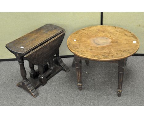 A small folding stained oak drop leaf circular table and another, the first 49.5 cm high x 54 cm diameter, the second with ea