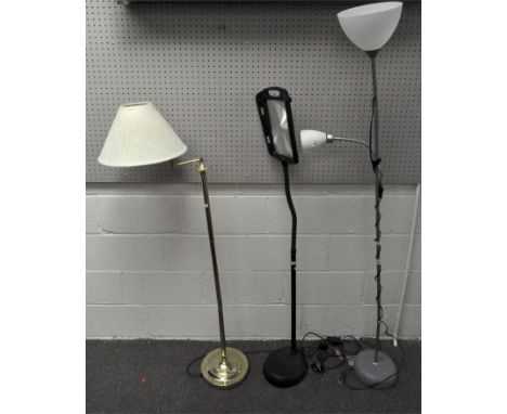 Two modern standard lamps and a magnifier, including: a gilt metal mounted example with adjustable lamp with cream shade, an 