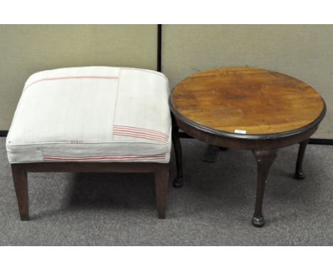 A 20th century mahogany coffee table and a footstool upholstered in cream and red cotton, the first 41 cm high x 55 cm diamet
