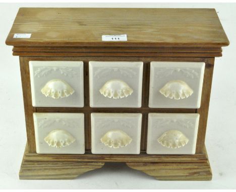 A vintage spice rack with six ceramic drawers, 26cm x 34cm x 14cm