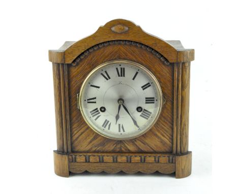 An oak cased Hamburg Clock Company mantel clock, the silvered dial with Roman numerals denoting hours, 28cm x 24.5cm x 13cm