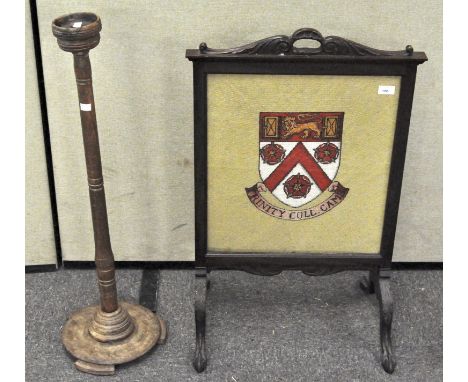 A mahogany framed fire screen with 'Trinity College' tapestry; together with a large Church candlestick