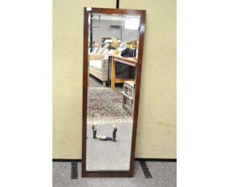 A rectangular oak framed mirror with bevelled edge, 120cm x 39cm