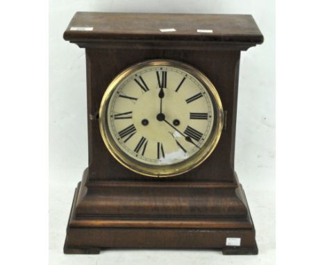 A Victorian mantel clock in a mahogany case, the dial with Roman numerals denoting hours, 42cm high
