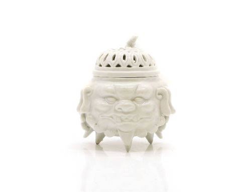 A Blanc de Chine porcelain pot pourri  19th century, modelled as the head of a dog of fo, the pierced cover with a finial mod