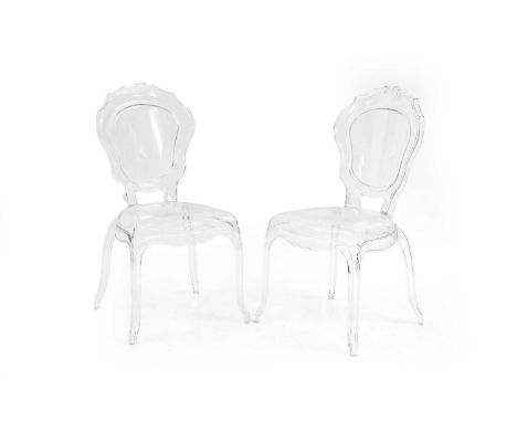 A pair of clear polycarbonate open armchairs, 20th century, the cartouche shaped back above serpentine seat on cabriole suppo