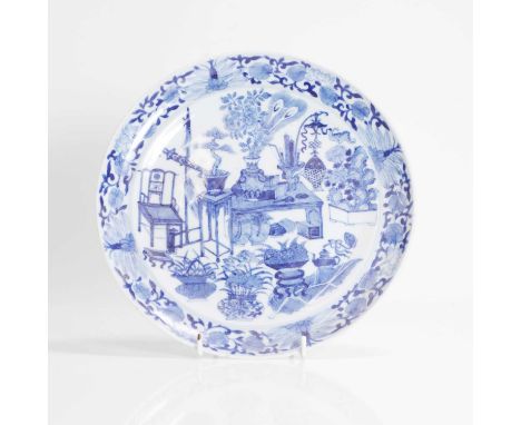 A Chinese export blue and white plate, 18th century, of circular form, painted with precious objects in a sitting room, 24cm 