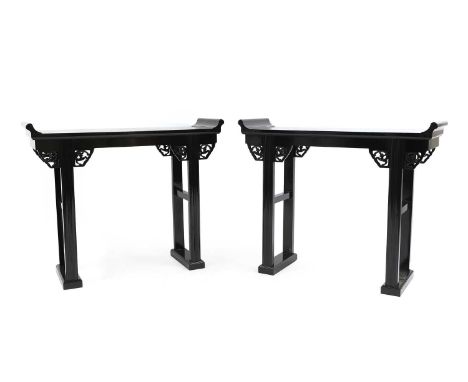 A pair of Chinese ebonised alter tables, 20th century, the rectangular top with scroll ends on stretchered square section sup