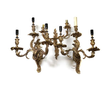A pair of Louis XV ormolu three light wall sconces fitted triple scrolling foliage branches 40cm wide 46cm high together with