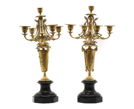 A pair of gilt metal candelabra 20th century, with a foliate sconce, leading to four branches, above an urn, on slate bases,4