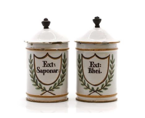 A pair of pottery apothecary jars and covers, late 18th/ early 19th century, probably Dutch, with shield cartouche, and laure