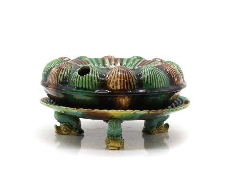 A Majolica pottery spittoon  19th century, the edge moulded with scallop shells, in motteld green and brown glaze 22cm diamet