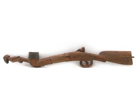 A novelty pipe, 20th Century, in the form of a rifle with a figure standing on the end, possibly Chokwe, 65cm longCondition R