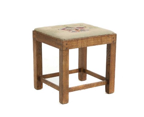 An oak stool, early to mid 20th century, the needlework seat worked with arms, inscribed 'Roberts of Glassenbury, together wi