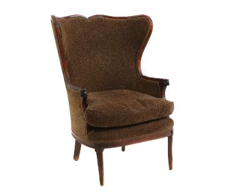 A French mahogany framed wing back armchair 19th century, upholsteted in a leopard print velvet fabric, loose cushion seat wi