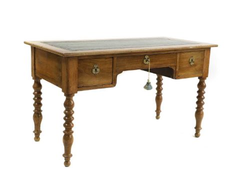 A fruitwood desk late 19th century, French, the leather inset top over three drawers fitted with brass escutcheons raised on 