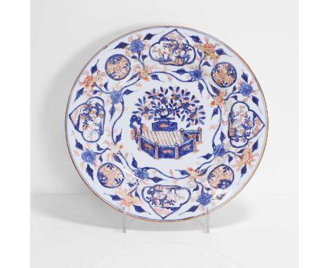 A Chinese Imari-style charger, Kangxi (1662-1722), of circular form, painted with blossoming trees in a garden in iron-red an