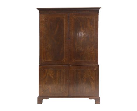 A strung and inlaid mahogany press cupboard 19th century, the moulded cornice over four doors with inlaid patera, the top two