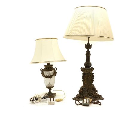 A Victorian cast metal table lamp, probably converted, with elaborate cast base, with panels of buildings, mounted with figur