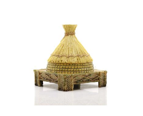 A George Jones majolica cheese dish and cover, c.1870, modelled in the form of a bee skep on a square wood stand, with a cent