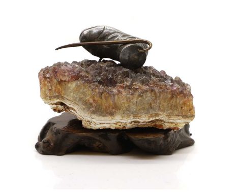 A pewter model  of a boot, mounted on a quartz base, and a wood stand, 12cm wide 7cm highProvenance: The Estate of the Late J
