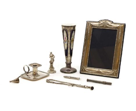 A silver photograph frame London 1994, decorated with bows, 13 x 20cm together with a silver chamberstick,Chester 1901, 8.5cm