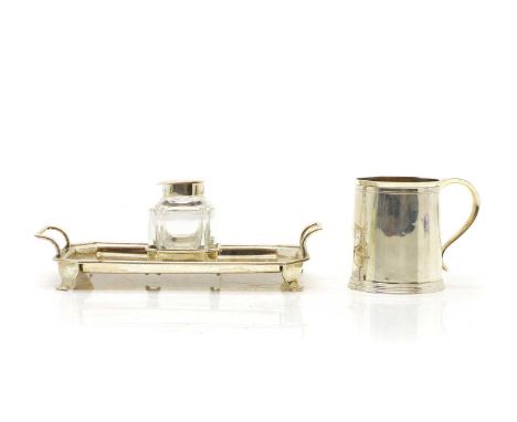 A silver desk stand by Martin, Hall &amp; Co, Sheffield 1903, with a central silver-topped glass inkwell,21.6cm wide,together