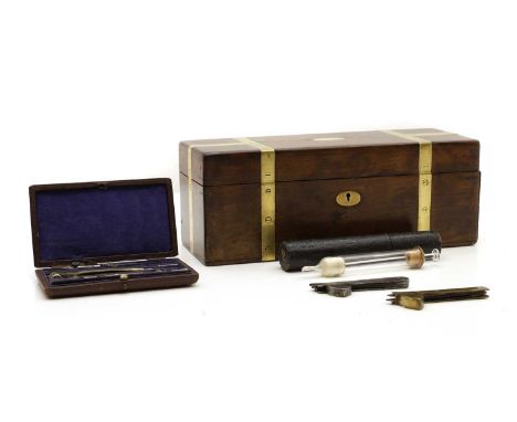 A mahogany and brass bound box, mid-19th century, 28cm wide, 10cm deep, 10.5cm high, together with, a glass syringe, in a lea