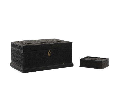 An Anglo-Indian carved ebony casket, mid 19th century, 24cm wide 14.5cm deep12cm high, and a small box, with a sliding lid, 1