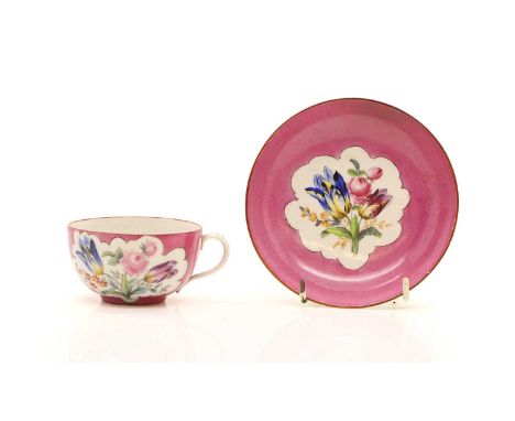 A Meissen porcelain teacup and saucer,  19th century, with floral sprays, to a pink ground, crossed sworders mark, the saucer