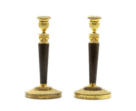 A pair of Continental Empire style gilt brass candlesticks 20th century, with mask and anthemion decorated capitals and scone