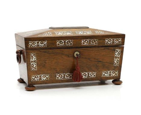 A Regency rosewood tea caddy, with mother of pearl inlay, the sarcophagus-shaped hinged lid opening to a marbled-paper lined 