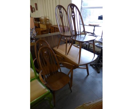 An Ercol Golden Dawn elm and beech Windsor drop leaf table and four chairs 