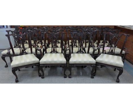 A set of twenty two Chippendale Revival carved mahogany dining chairs 