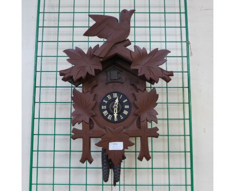 A West German carved wood effect cuckoo clock 