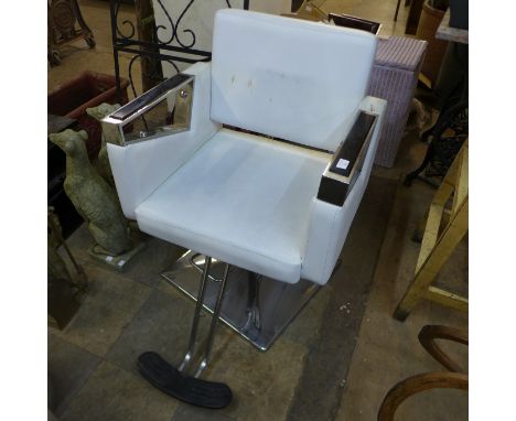 An Art Deco style chrome and faux cream leather barber's chair 