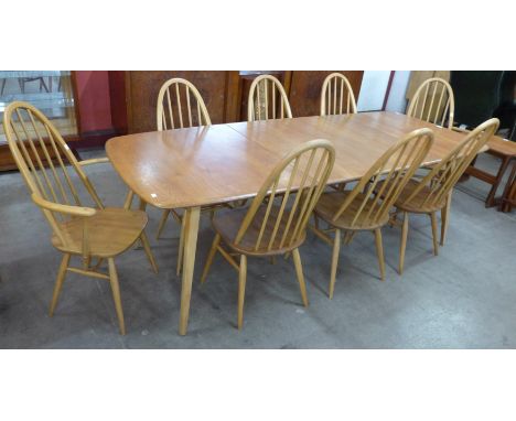 An Ercol Blonde elm and beech Grand Windsor extending dining table and eight Ercol Blonde Quaker model chairs 