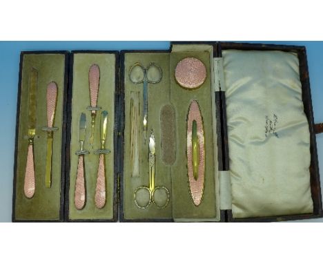 A lady's manicure set with pink guilloche enamel style decoration in a fitted box